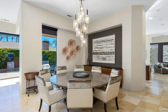a dining room with furniture and wooden floor