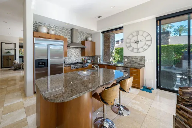 a view of a patio with couches and table and chairs and potted plants