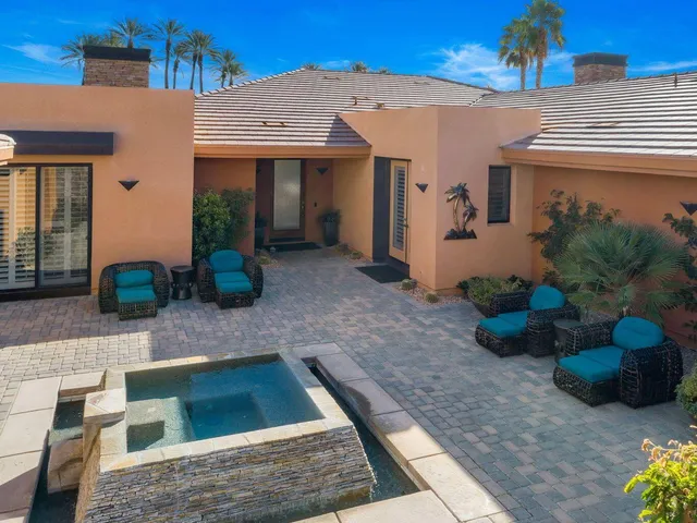 a view of a house with potted plants