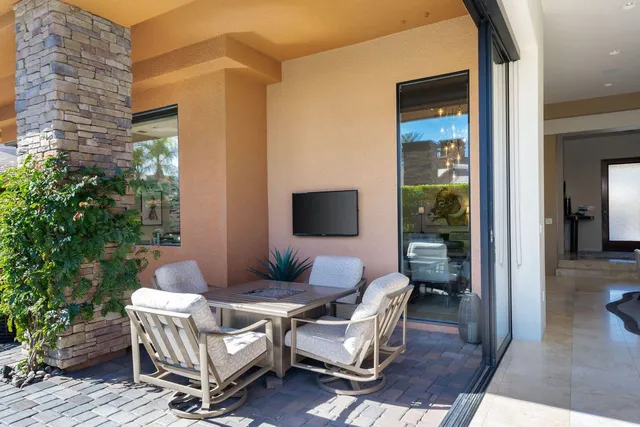 a bedroom with furniture and a flat screen tv