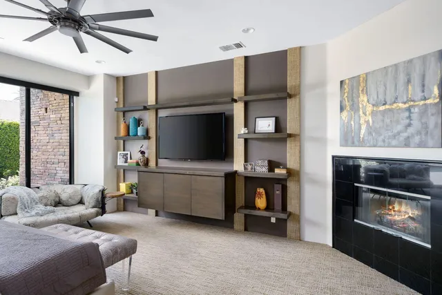 a spacious bedroom with a bed and a ceiling fan