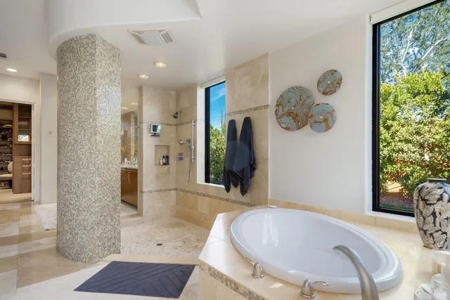 a bathroom with a double vanity sink toilet and shower
