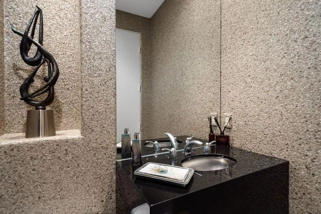 a bedroom with a large bed and a ceiling fan