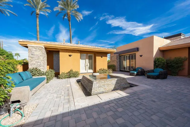 a view of swimming pool with outdoor seating and plants