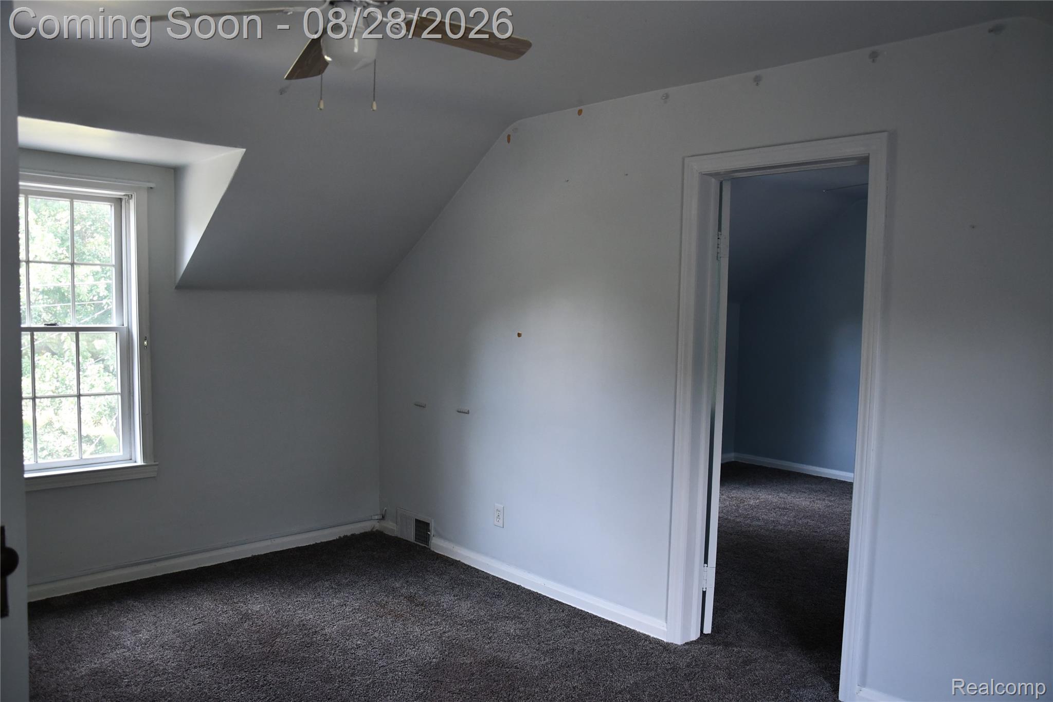 9039 Peer Road South Lyon, MI 48178 - Photo 41 of 47 Sloped ceiling bedroom featuring a double-hung window, ceiling fan, and gray carpeting