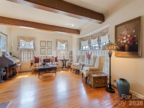 a living room with furniture wooden floor and a fireplace