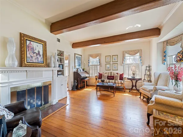 a living room with furniture a fireplace and a table