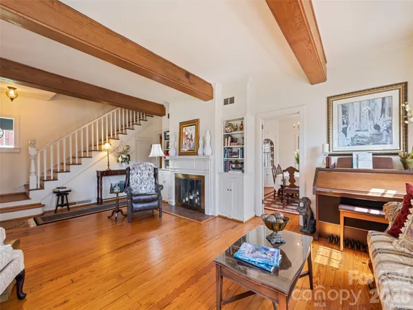 a dining room with furniture a chandelier and window