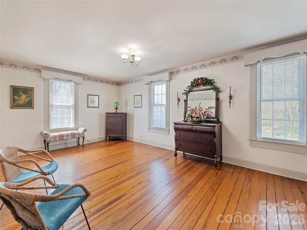 a view of a livingroom with wooden floor and staircase