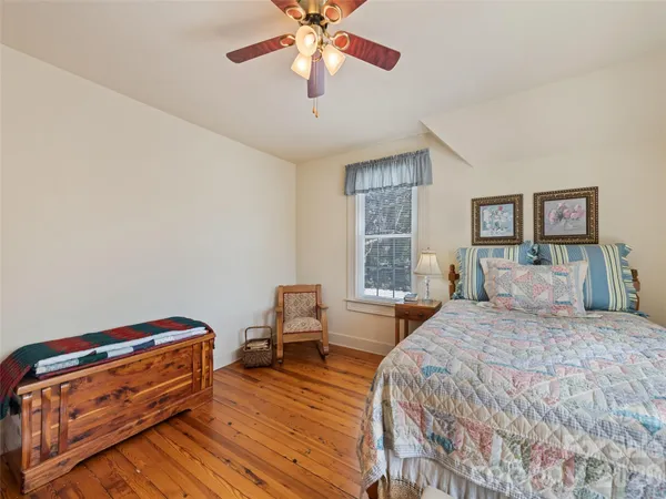 a bedroom with furniture and a window