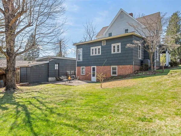 a view of house with yard and swimming pool
