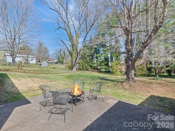 a view of a lake with a table and chairs in the patio