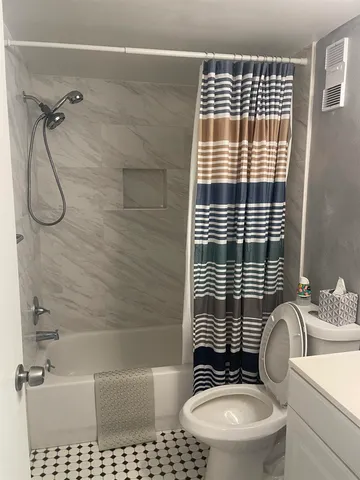 a bathroom with a toilet a sink and shower