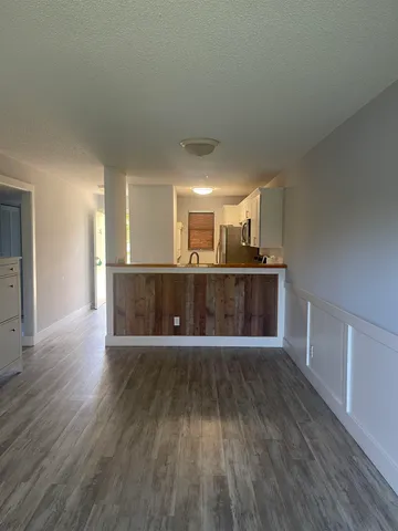 a view of a kitchen with a sink and wooden floor