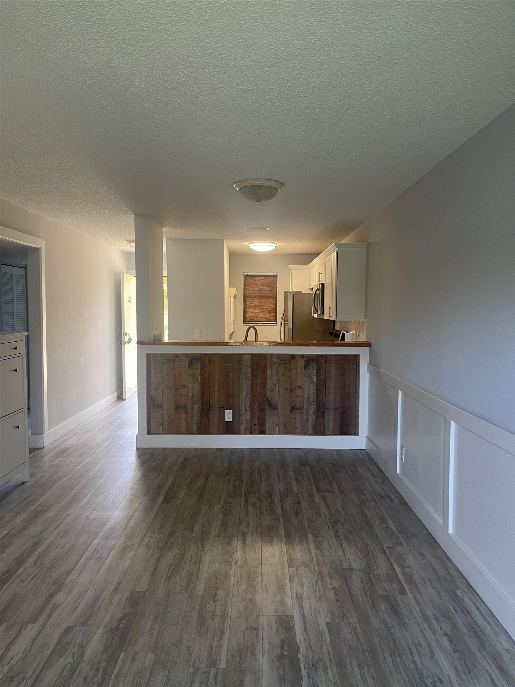 650 West Pope Road, Unit 276 St. Augustine, FL 32080 - Photo 9 of 15 a view of a kitchen with a sink and wooden floor