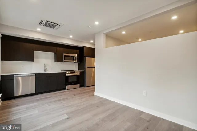 a large white kitchen with a sink