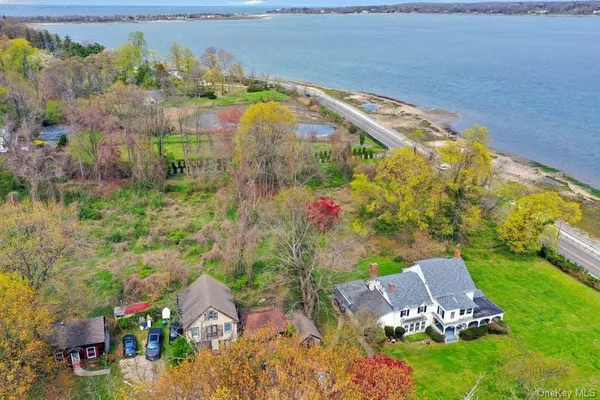 an aerial view of a house with a garden and lake view