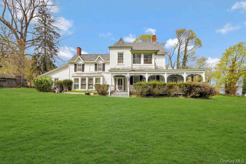 1008 West Shore Road Mill Neck, NY 11765 - Photo 2 of 8 a front view of a house with a garden