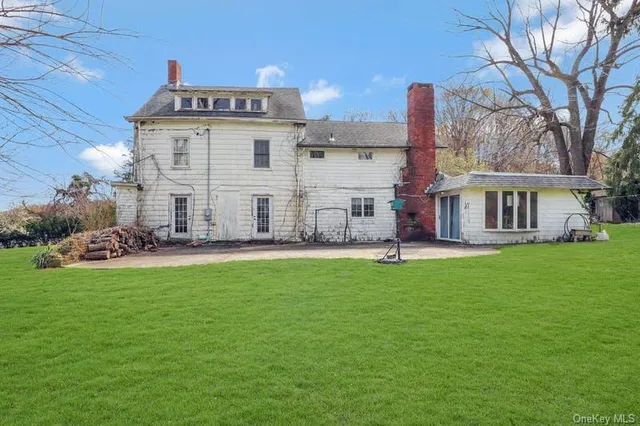 a view of a house with a backyard porch and sitting area
