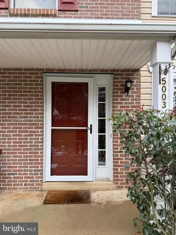 a front view of a house with a door and a window