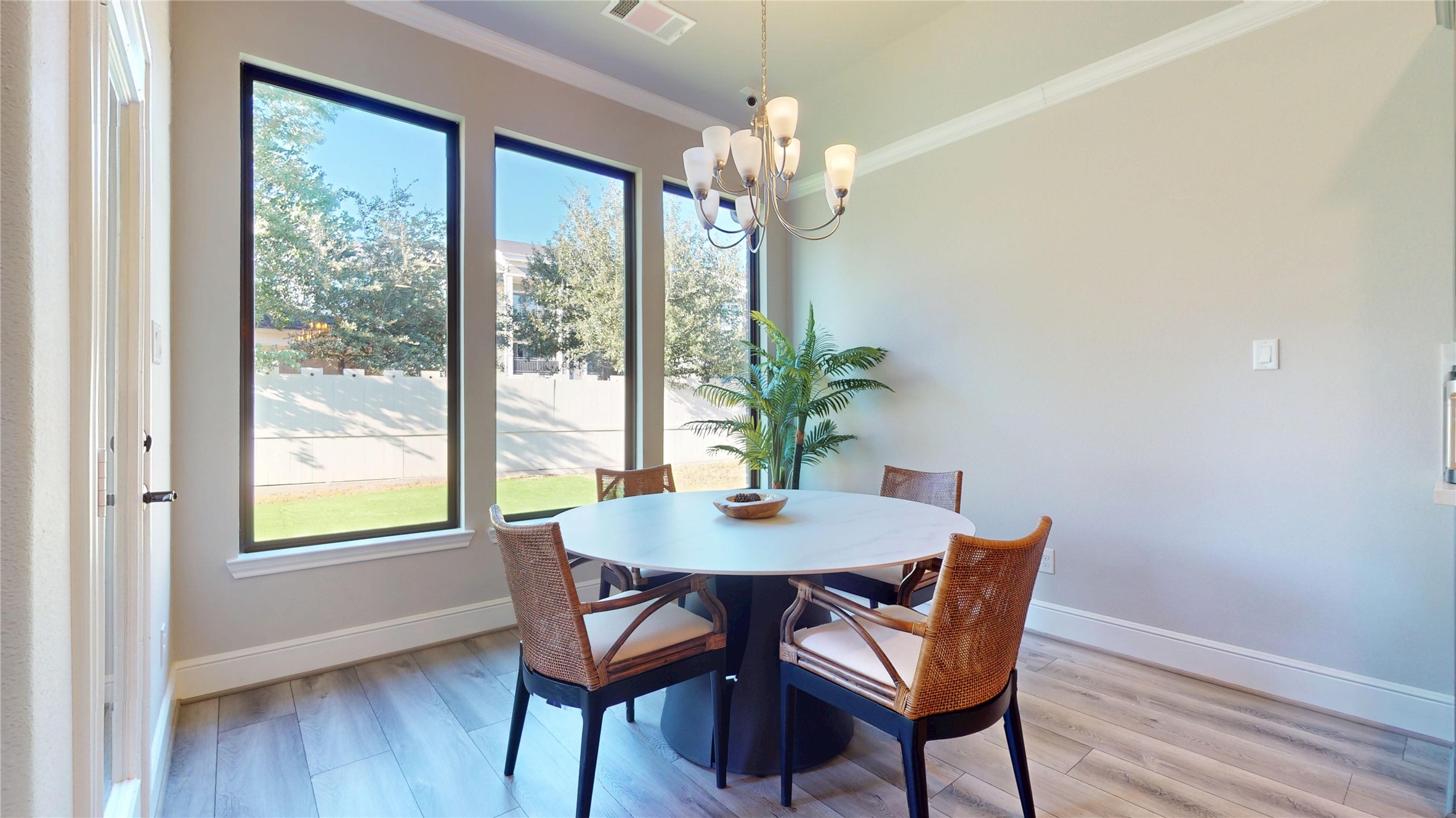 8305 Greenleaf Ridge Way Conroe, TX 77385 - Photo 9 of 33 a dining room with furniture wooden floor a potted plant and a chandelier