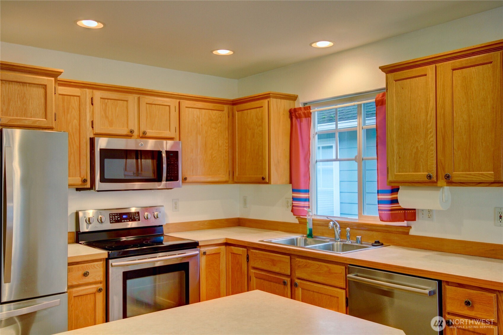 1072 Sinclair Way, Unit 56 Burlington, WA 98233 - Photo 11 of 29 a kitchen with stainless steel appliances a stove sink and microwave