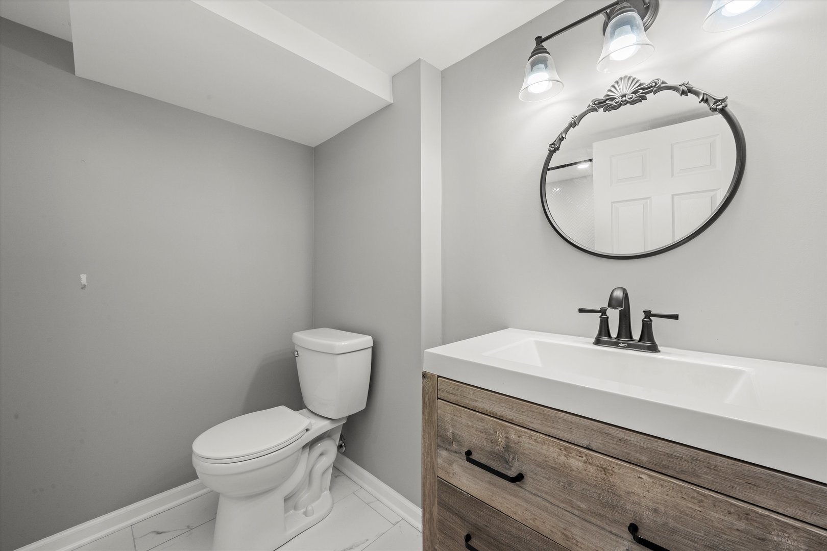1212 Grandview Avenue Lockport, IL 60441 - Photo 23 of 38 a bathroom with a toilet a sink and mirror