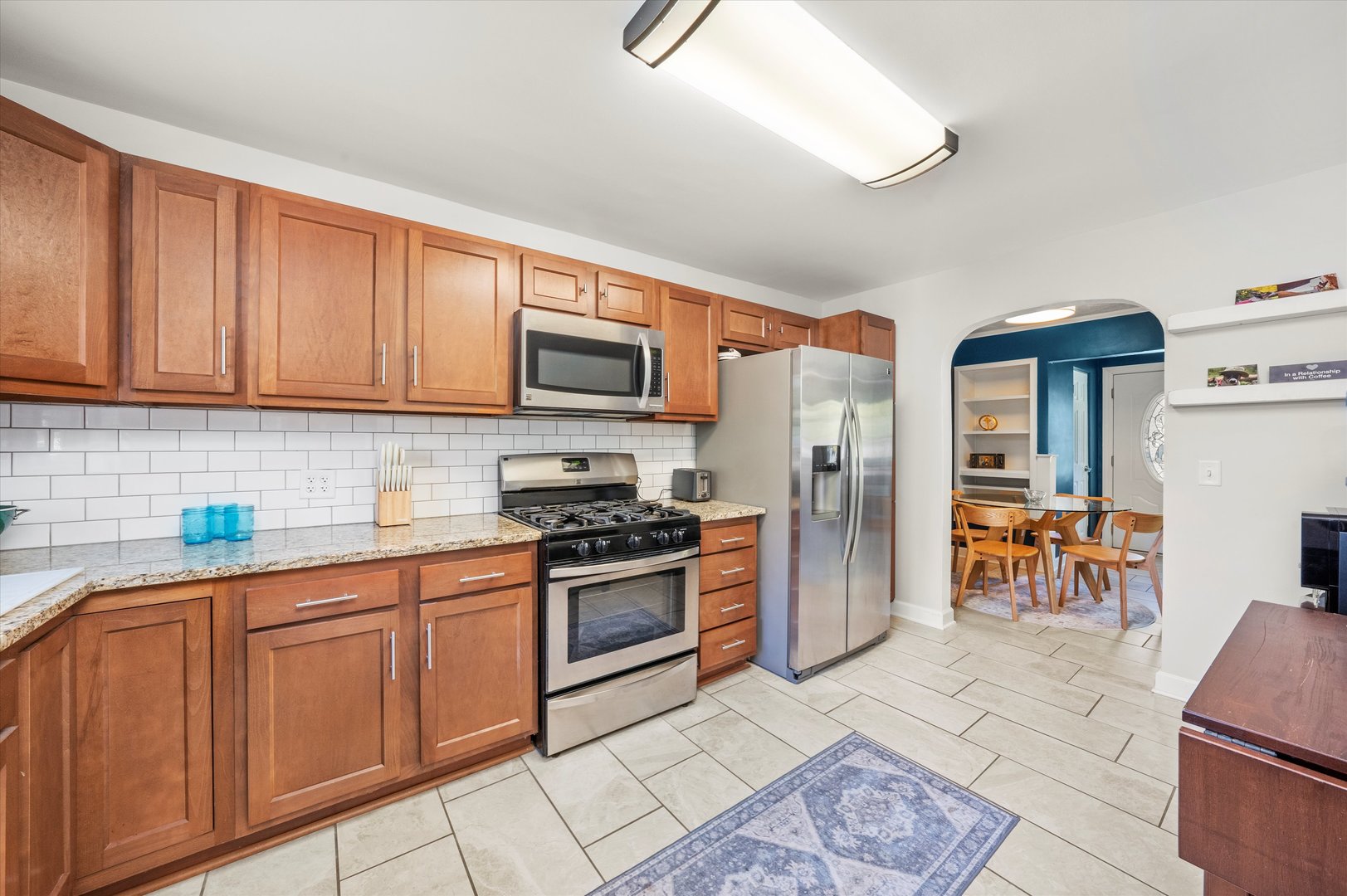 1212 Grandview Avenue Lockport, IL 60441 - Photo 8 of 38 a kitchen with stainless steel appliances granite countertop a stove top oven a sink a dining table and chairs