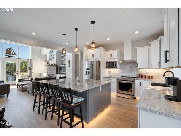 a large kitchen with a table and chairs