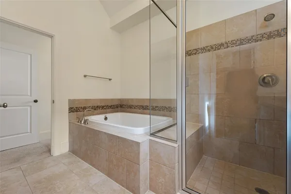 a bathroom with a granite countertop sink a shower and mirror