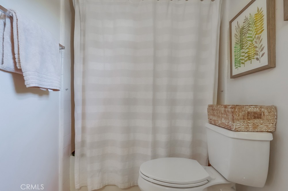 1749 Compromise Line Road Glendora, CA 91740 - Photo 29 of 44 a white toilet sitting next to a shower curtain