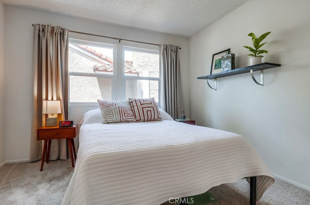 1749 Compromise Line Road Glendora, CA 91740 - Photo 35 of 44 a bedroom with a bed table chair and a window