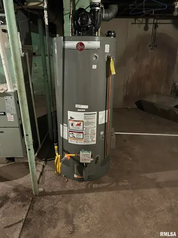 a view of a hallway with chandelier and front door