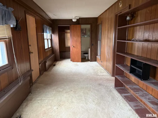 a view of an empty room with windows