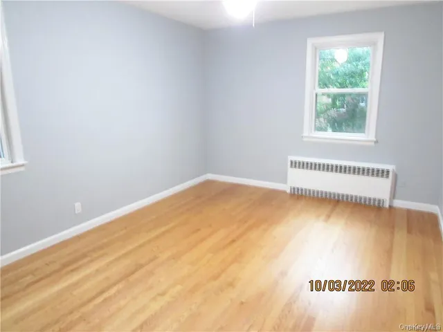 a view of a room with wooden floor and windows
