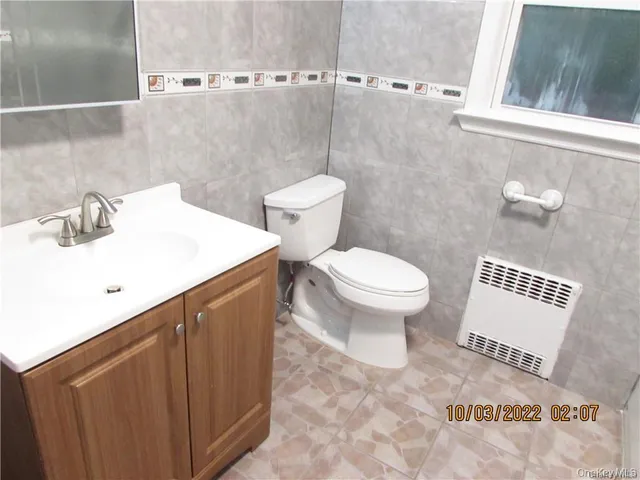 a bathroom with a sink toilet and a mirror