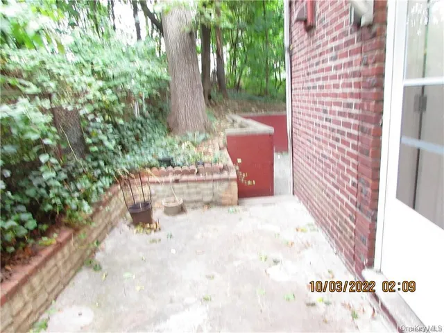 a view of a patio with table and chairs and potted plants
