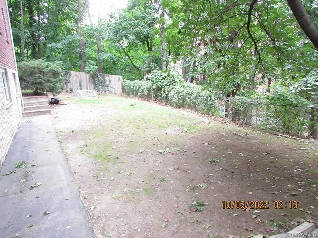 a view of a yard with large trees