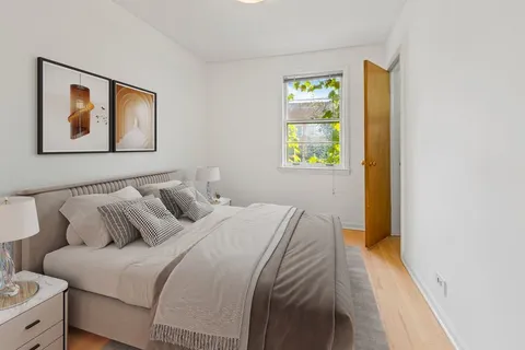 a bedroom with bed and a window