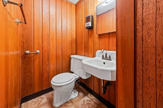 a bathroom with a sink a toilet and shower curtain