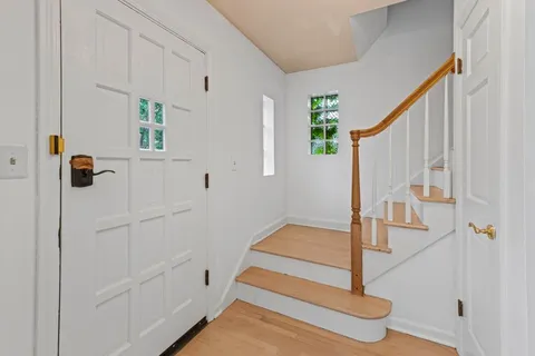 a view of entryway with wooden floor and stairs