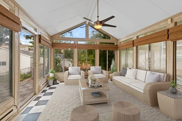 a living room with patio furniture and a large window