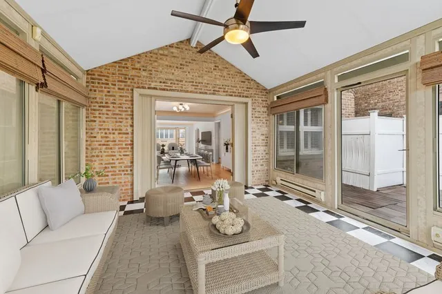 a living room with furniture and floor to ceiling window