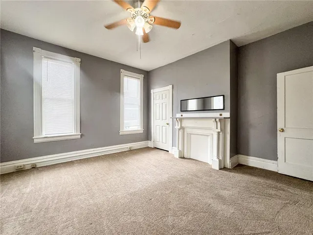 an empty room with windows and cabinet