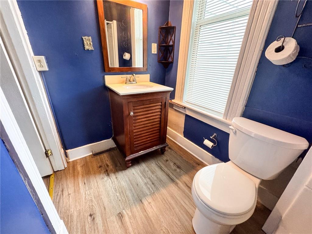 411 Cherry Street, Unit 1 Butler, PA 16001 - Photo 16 of 16 a bathroom with a toilet a sink and a mirror