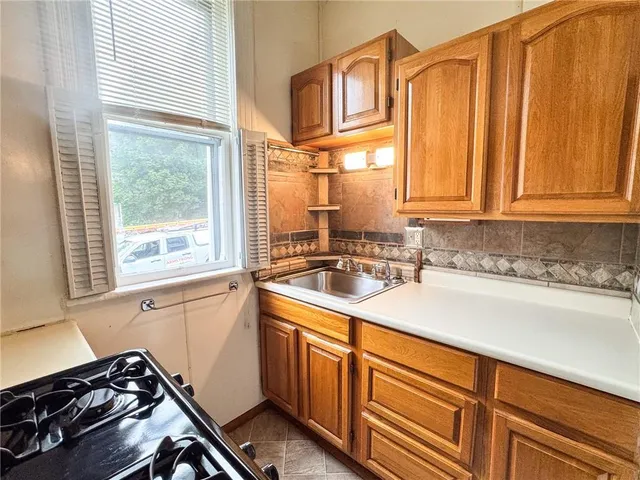 a kitchen with stainless steel appliances granite countertop a sink a stove and a microwave