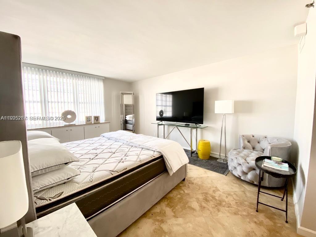 100 Lincoln Road, Unit 608 Miami Beach, FL 33139 - Photo 11 of 20 a bedroom with a bed and a flat screen tv