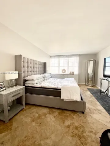 a spacious bedroom with a bed and window
