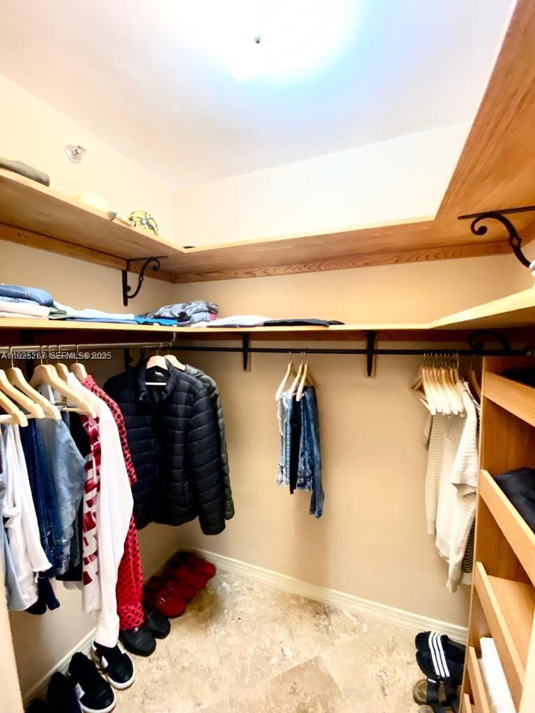 100 Lincoln Road, Unit 608 Miami Beach, FL 33139 - Photo 14 of 20 a view of walk in closet with clothes and shoes