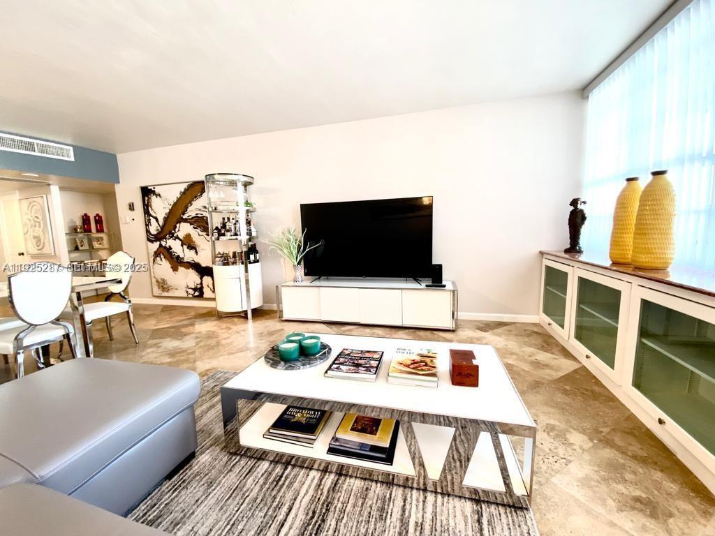 100 Lincoln Road, Unit 608 Miami Beach, FL 33139 - Photo 3 of 20 a living room with furniture and a flat screen tv